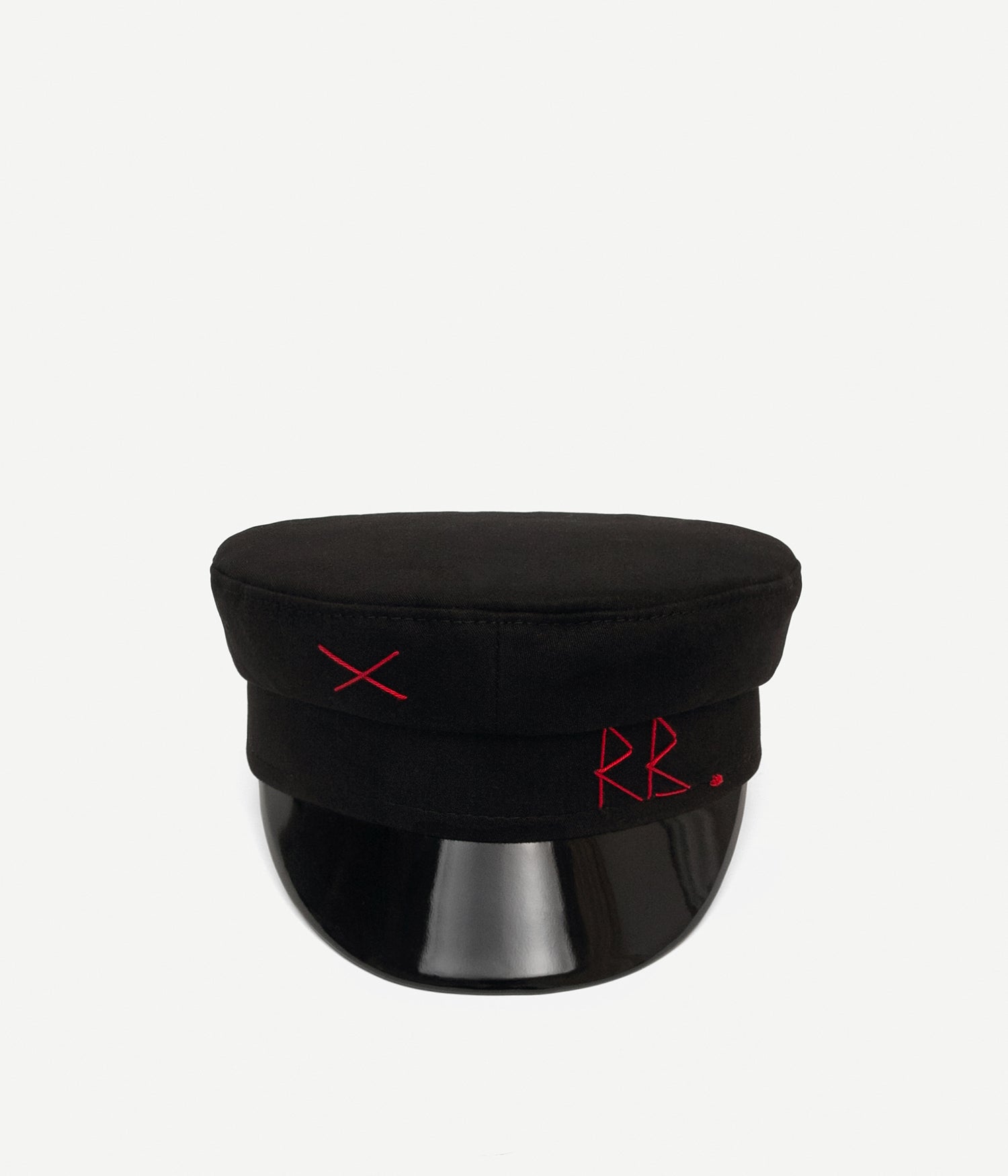 44_00, Ruslan Baginskiy black baker boy cap is our first and most recognizable piece. The silhouette, inspired by French train conductor headwear, is developed to flatter every face shape and every look.Black cotton baker boy cap is the classic iteration. It comes in lightweight cotton, hand-embroidered with red RB initials and a cross. A glossy peak is another signature element of this style, adding more definition to the whole look. When creating an outfit, you don’t need to get your thinking cap on — simply try your baker boy cap. 
