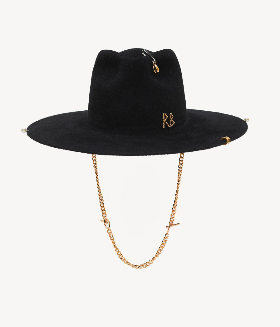 44_10_40, Ruslan Baginskiy Fedora Hat features all kinds of our favorite embellishments. A gold-tone RB logo, gold-tone pins, a pearl, and a silver-tone safety pin with a seashell are scattered across the black felt canvas, having zero chance to go unnoticed. The elongated detachable chain is the main trim of this signature combination. And even if Rolling Stones were right, singing that you can't always get what you want, there are some exceptions to this rule. With this hat, you can get everything at once.