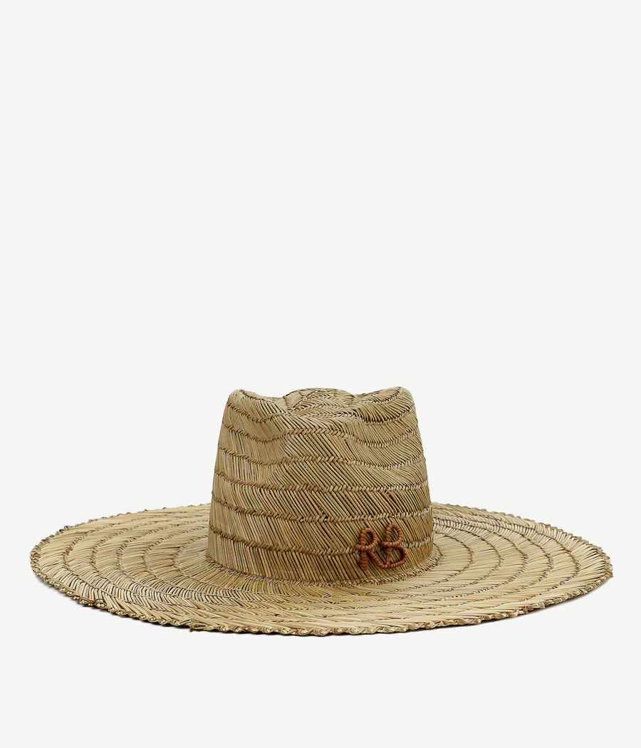 All Hat shapes, Ruslan Baginskiy reiterates a class of fedora through the prism of an uncomplicated summertime attitude. Rural motifs blend with the essence of millinery. Raw straws, meticulously crafted into an elaborate shape, deliver robust aesthetics. RB monogram stands for the feel of a community.