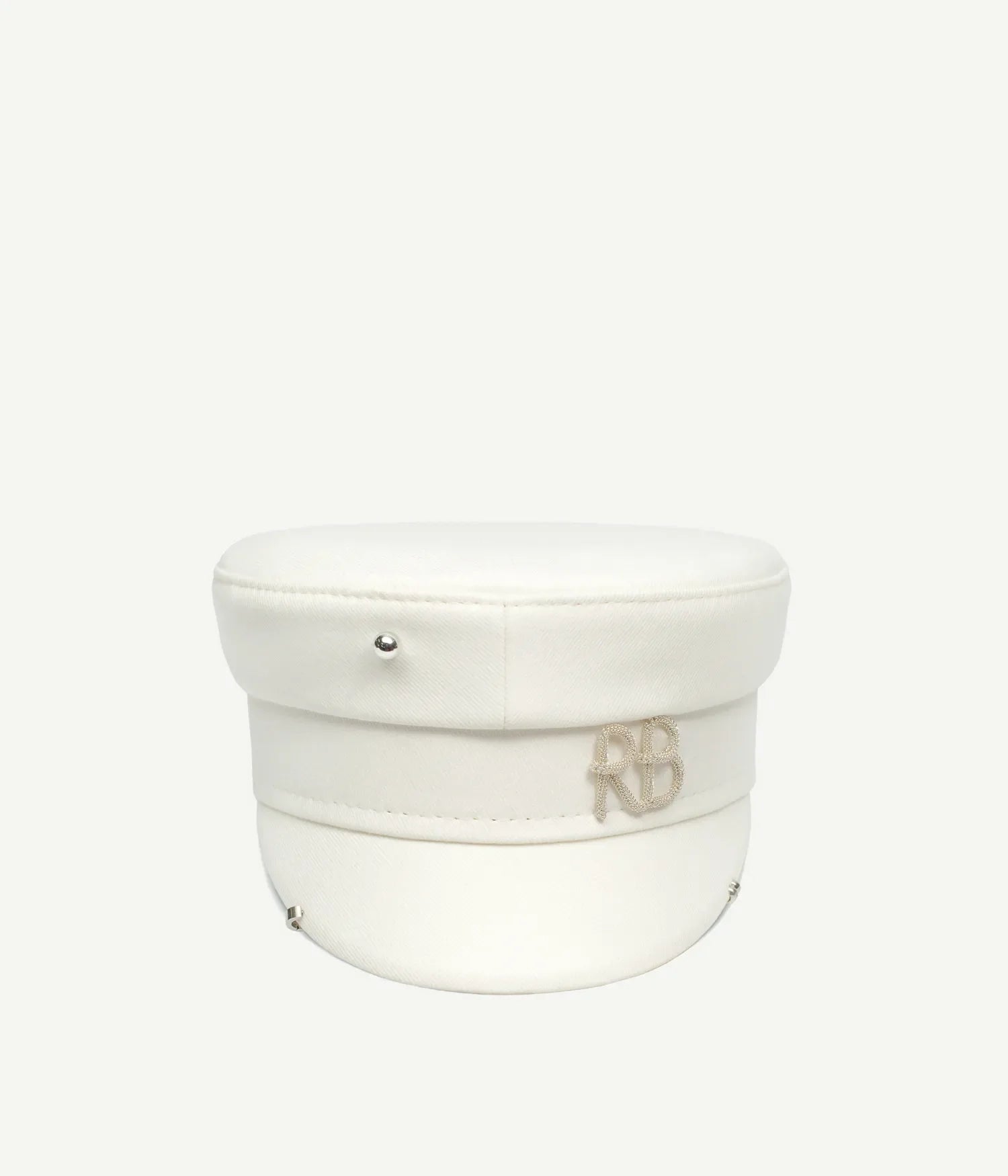 44_10_40, Ivory baker boy cap with pierced logo plaque, featuring a polyester, viscose, and elastane blend exterior. Artisanal craftsmanship.